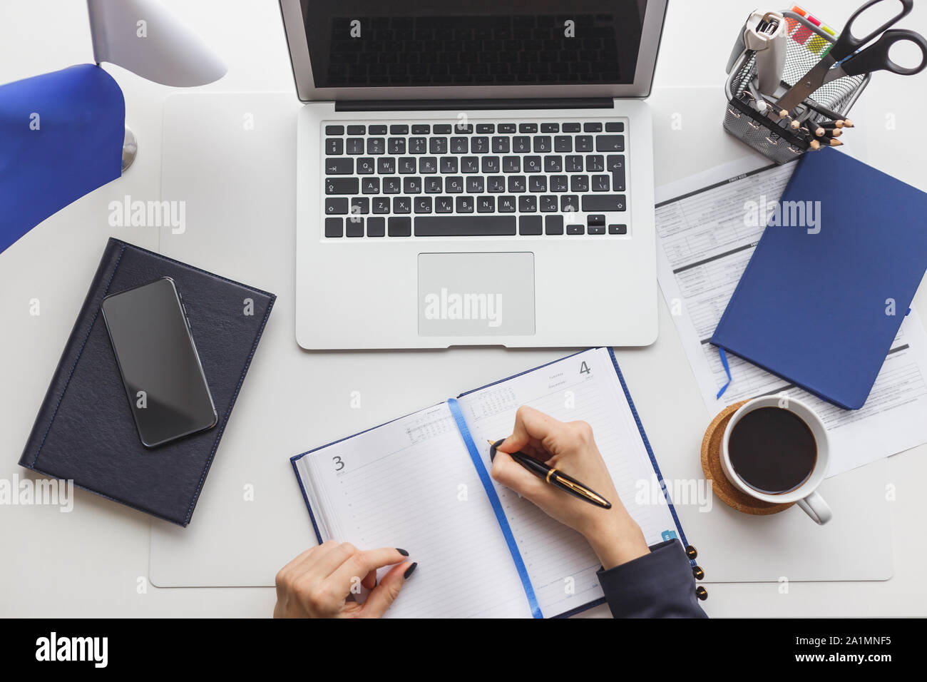 Businesswoman At Her Workplace Immersed In Work Stock Photo - Alamy