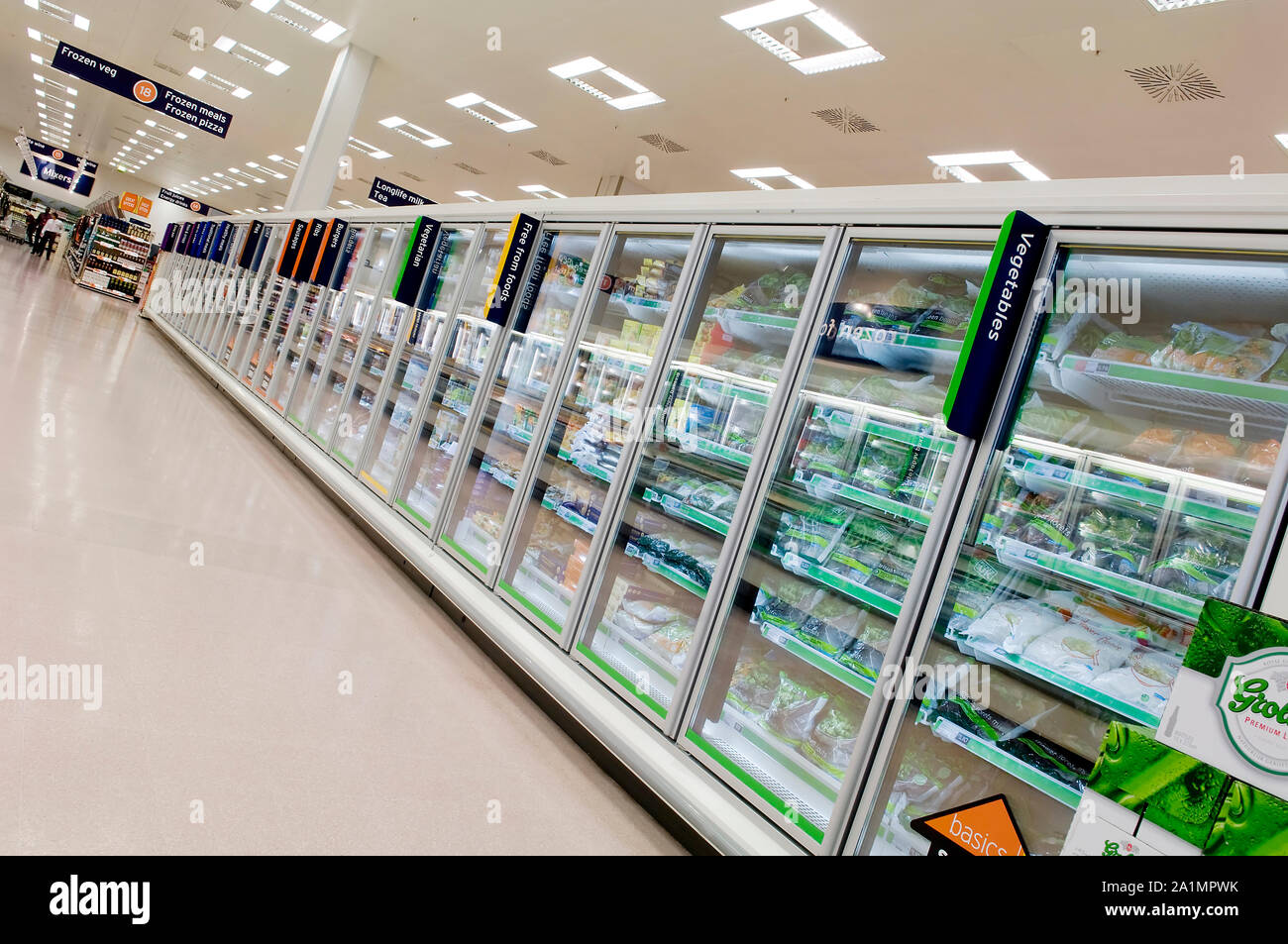 Rows of freezers in Sainsbury s freezer aisle full of frozen food