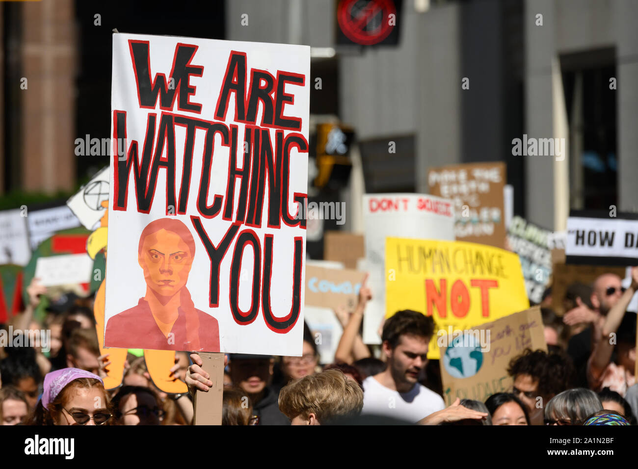 A demonstrator marches with a sign featuring Greta Thunberg during the Global Climate Strike in Toronto, Ontario on September 27, 2019. Stock Photo