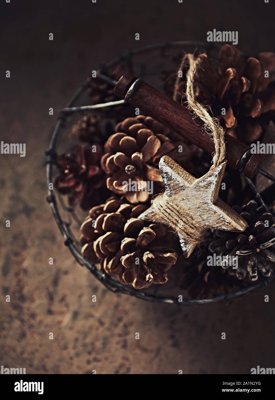 Pine Cones and Wooden Christmas Stars in a Basket Stock Photo - Alamy