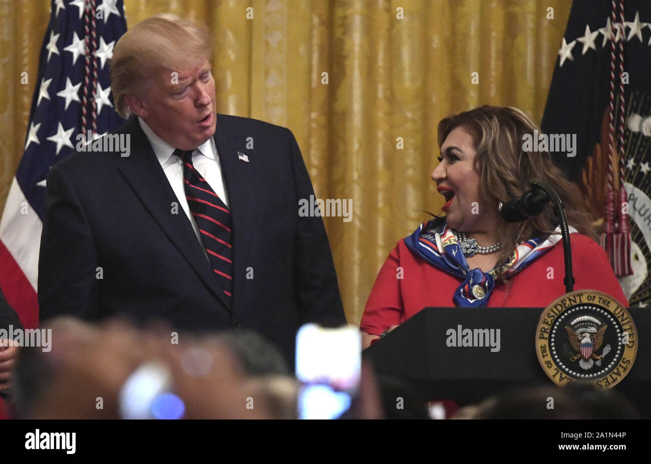Washington, United States. 27th Sep, 2019. President Donald Trump (L) welcomes Maria Rios, president and CEO of Nation Waste of Texas, to make remarks before the Hispanic Heritage Month reception in the East Room of the White House, Friday, September 27, 2019, in Washington, DC. Trump noted Latin achievements, Hispanics in his cabinet and advancing democracy in Latin America. Photo by Mike Theiler/UPI Credit: UPI/Alamy Live News Stock Photo