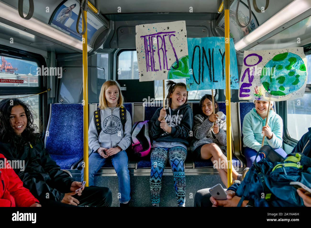 Young girls on bus with signs going to Greta Thunberg inspired Global Climate Strike, Vancouver, British Columbia, Canada Stock Photo