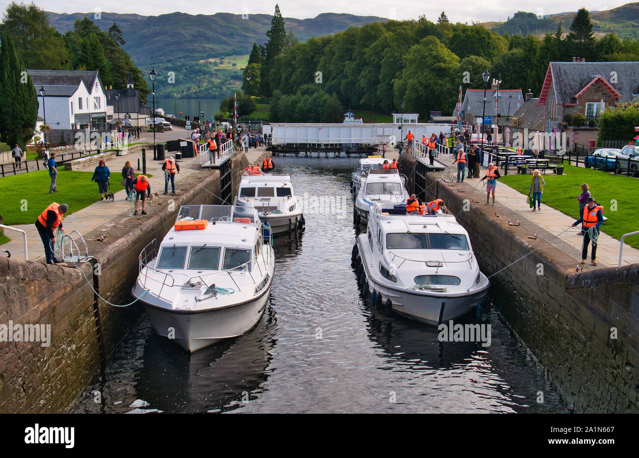 Leisure cruiser boats pass through the staircase locks at Fort Augustus in the Great Glen, Scotland, UK. Stock Photo