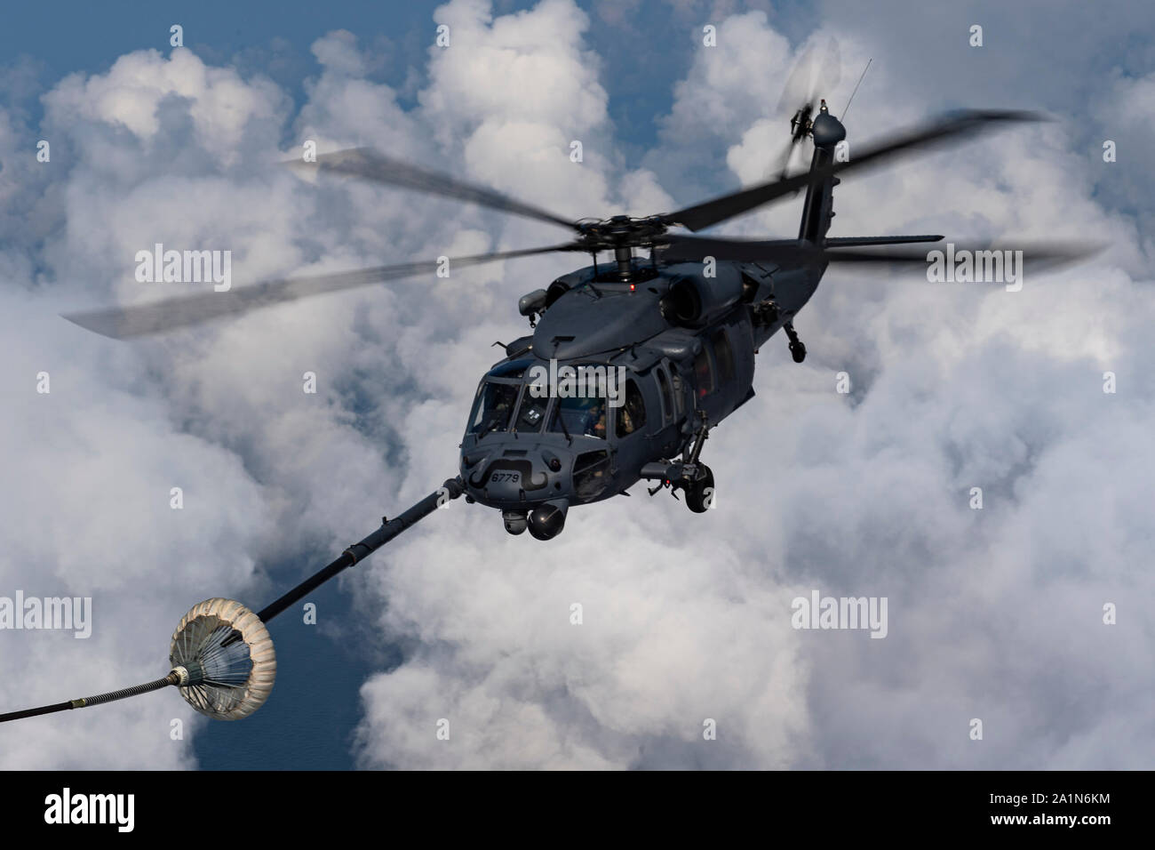 A U.S. Air Force HH-60G Pave Hawk connects with a drogue for helicopter air-to-air refueling in the skies above the Atlantic Ocean Sept. 7, 2019. U.S. Northern Command provided military-unique capabilities to the U.S. Agency for International Development, enabling the broader relief efforts addressing the acute humanitarian needs of the Bahamian people. (U.S. Air Force photo by Airman 1st Class Hayden Legg) Stock Photo