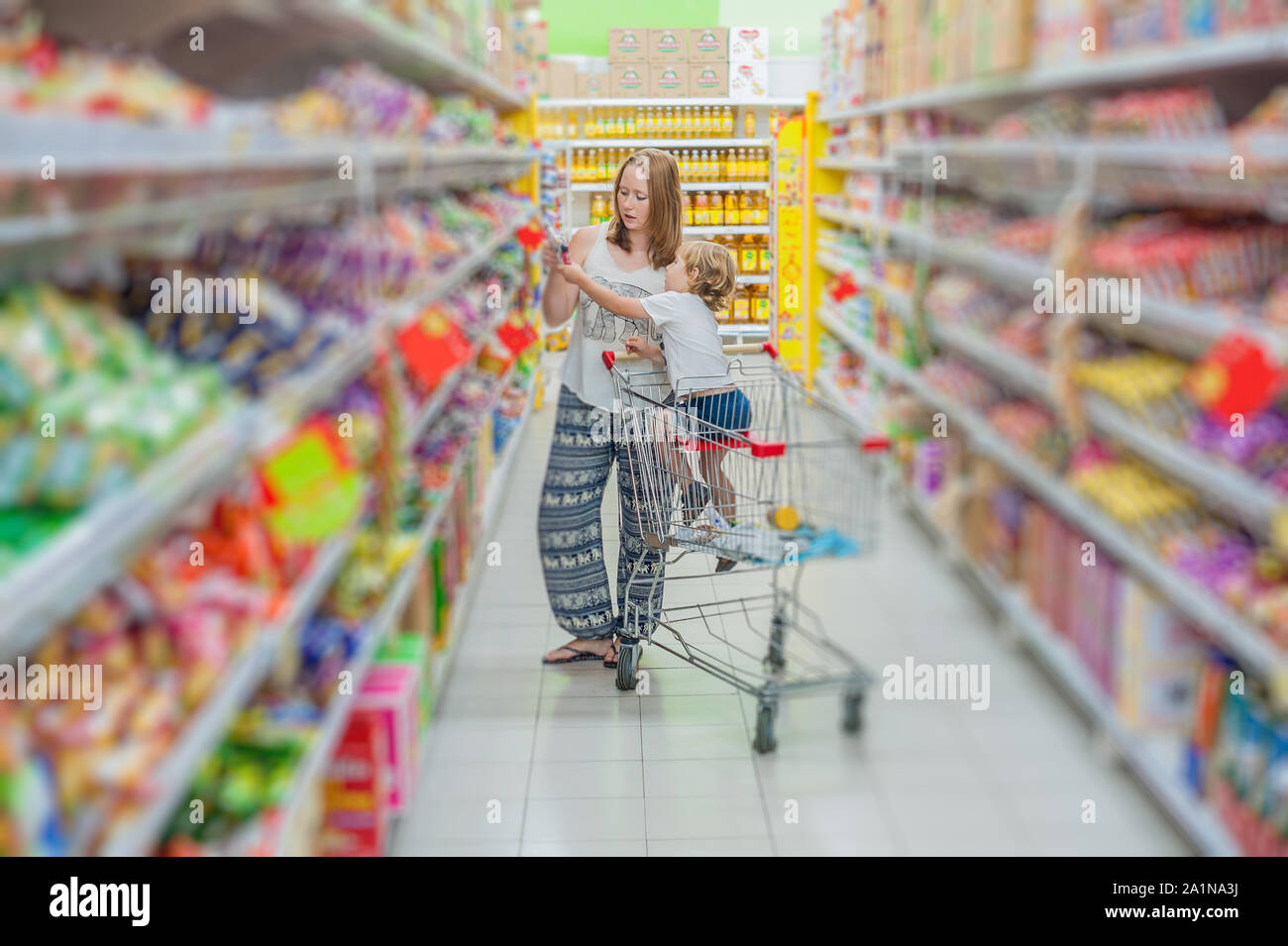 mother and her son buying food at a supermarket Stock Photo Alamy