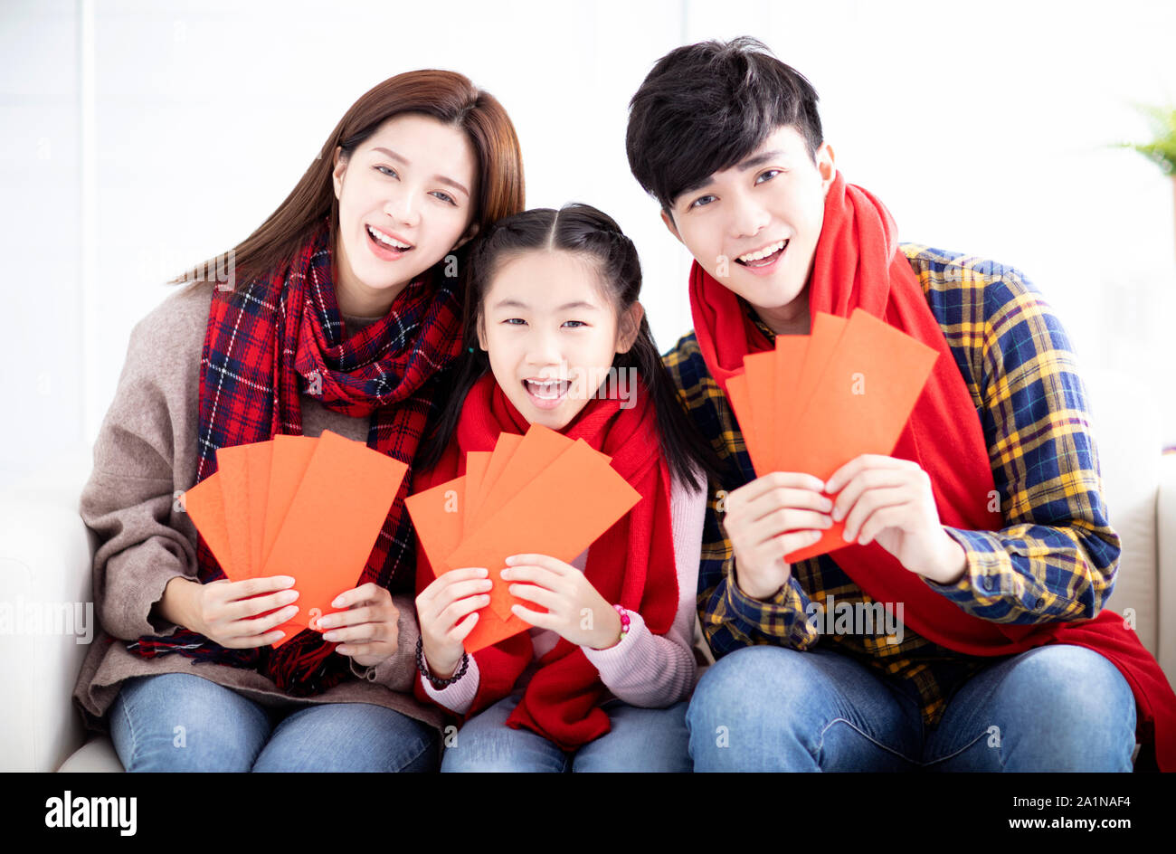 happy asian family showing red envelope for chinese new year Stock Photo