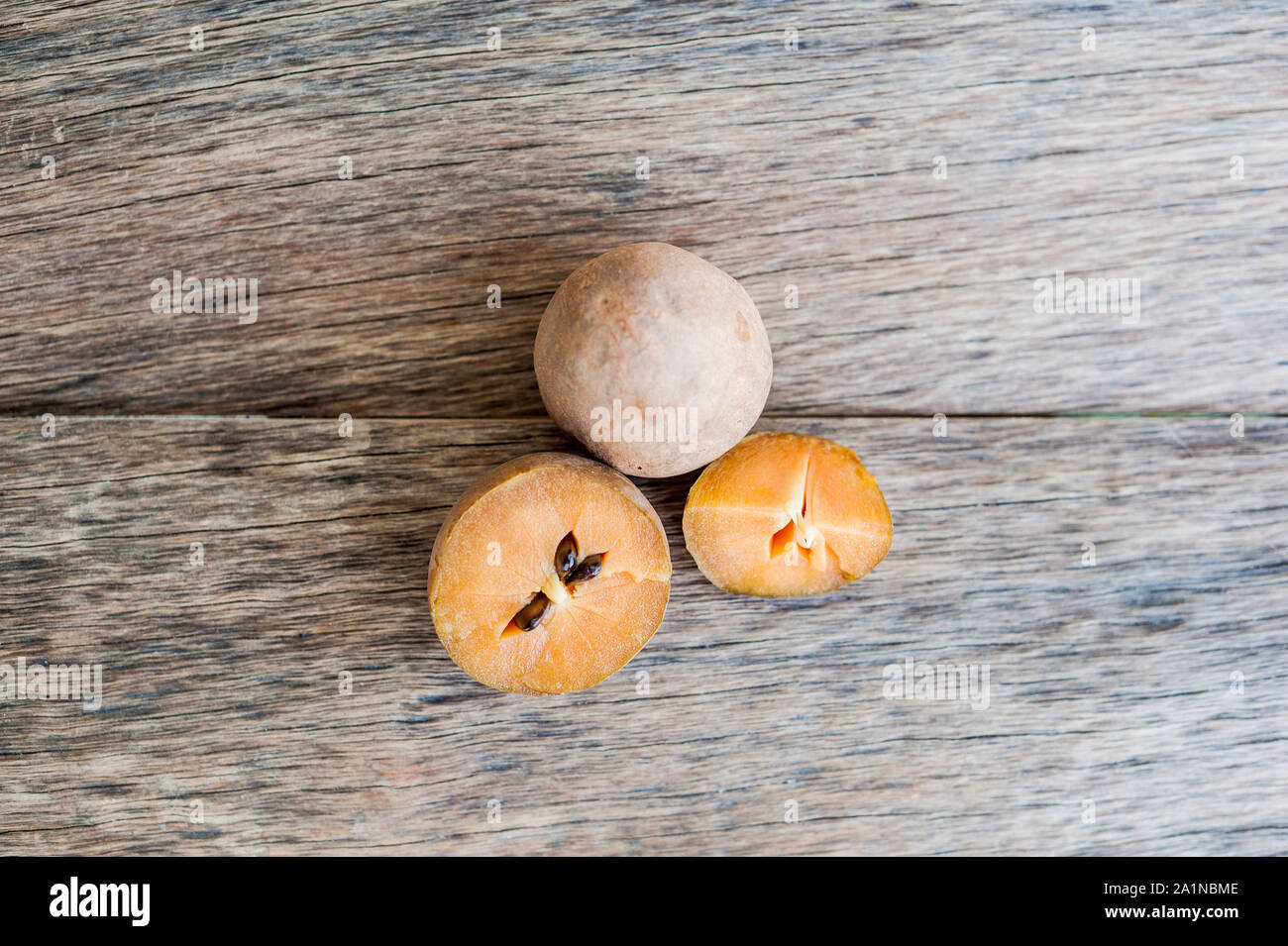 fresh sapodilla fruits on old wooden background Stock Photo