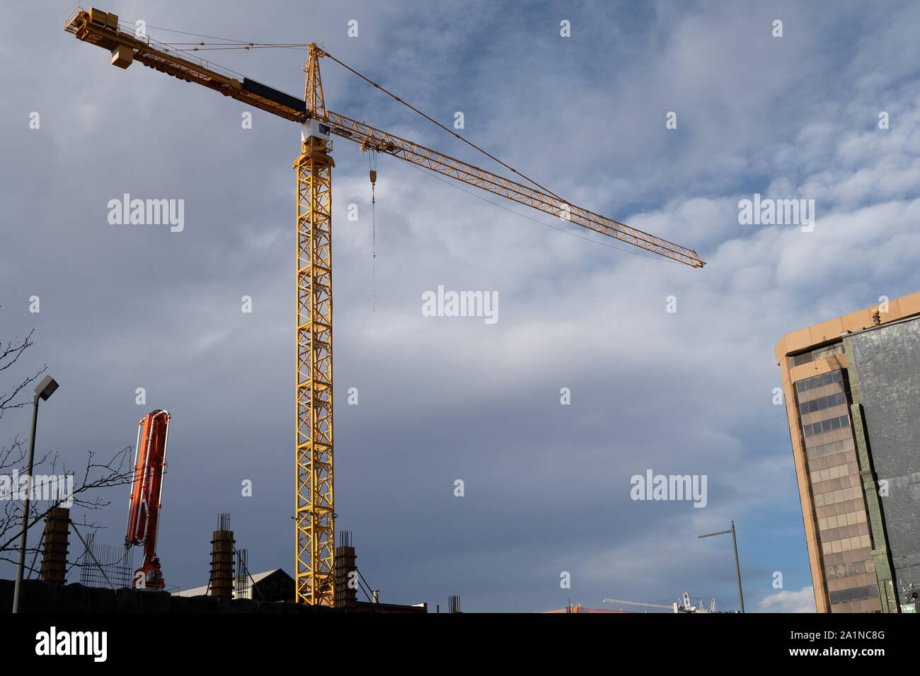 Construction Crane with dark clouds in the background with copy space. Stock Photo