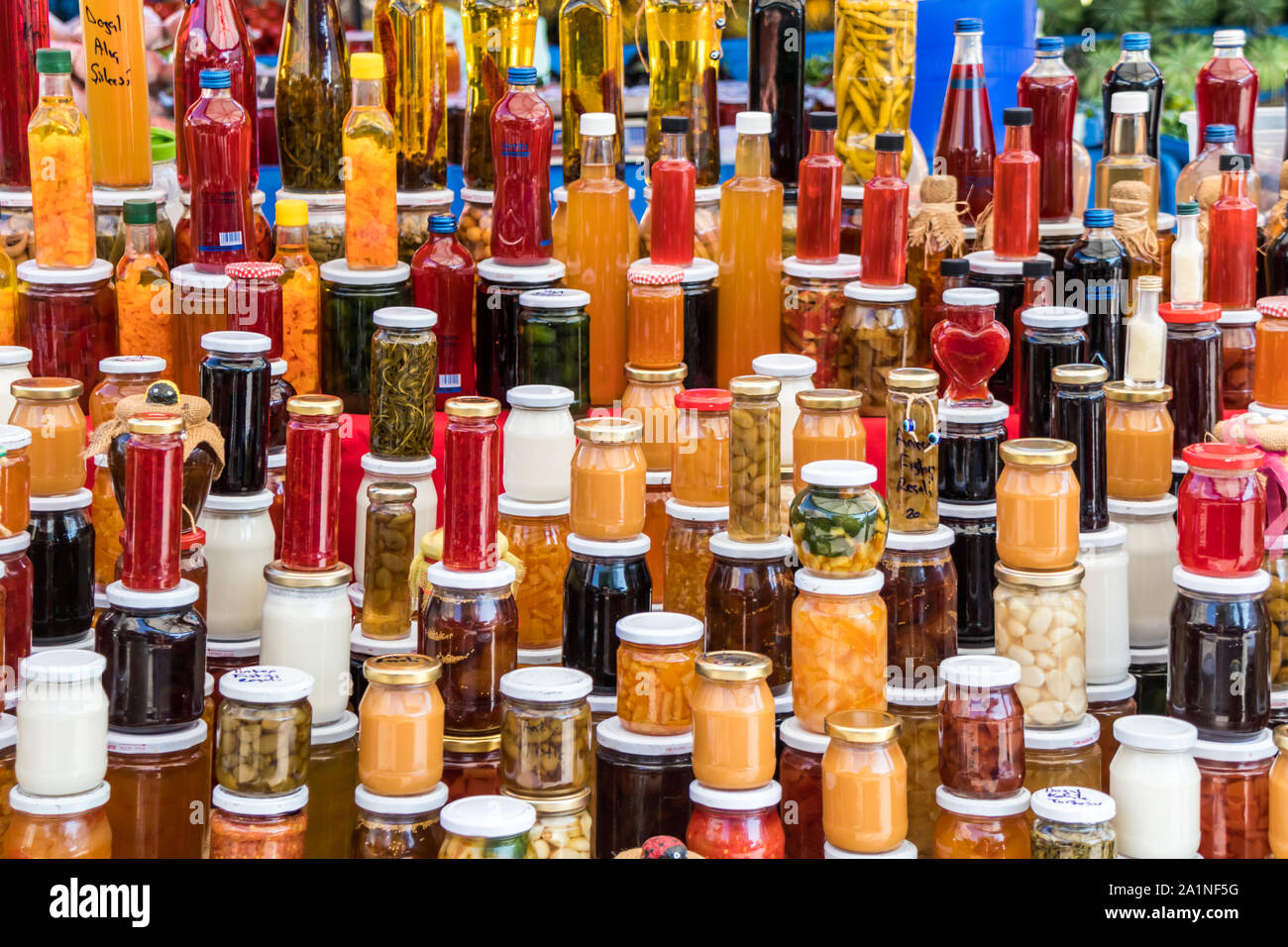 Jars and bottles of preserves, spices and pickles on Alacati market, Izmir, Turkey Stock Photo