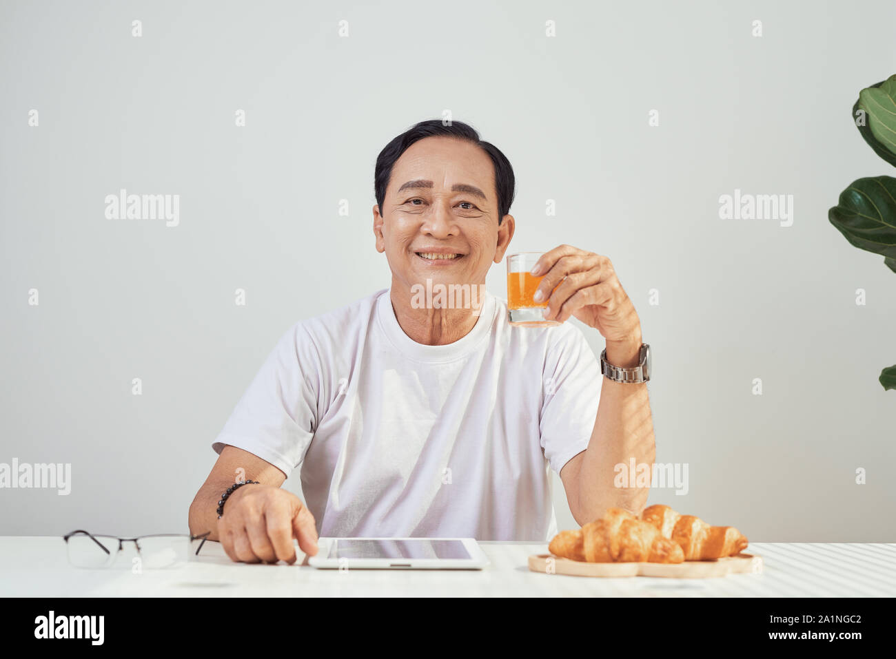 Senior Man Drinking Orange Juice High Resolution Stock Photography And Images Alamy