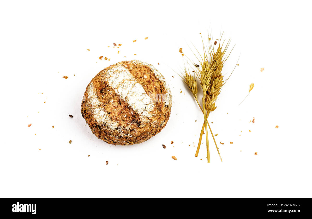 Wholemeal bread with seeds and ears of wheat isolated on a white ...