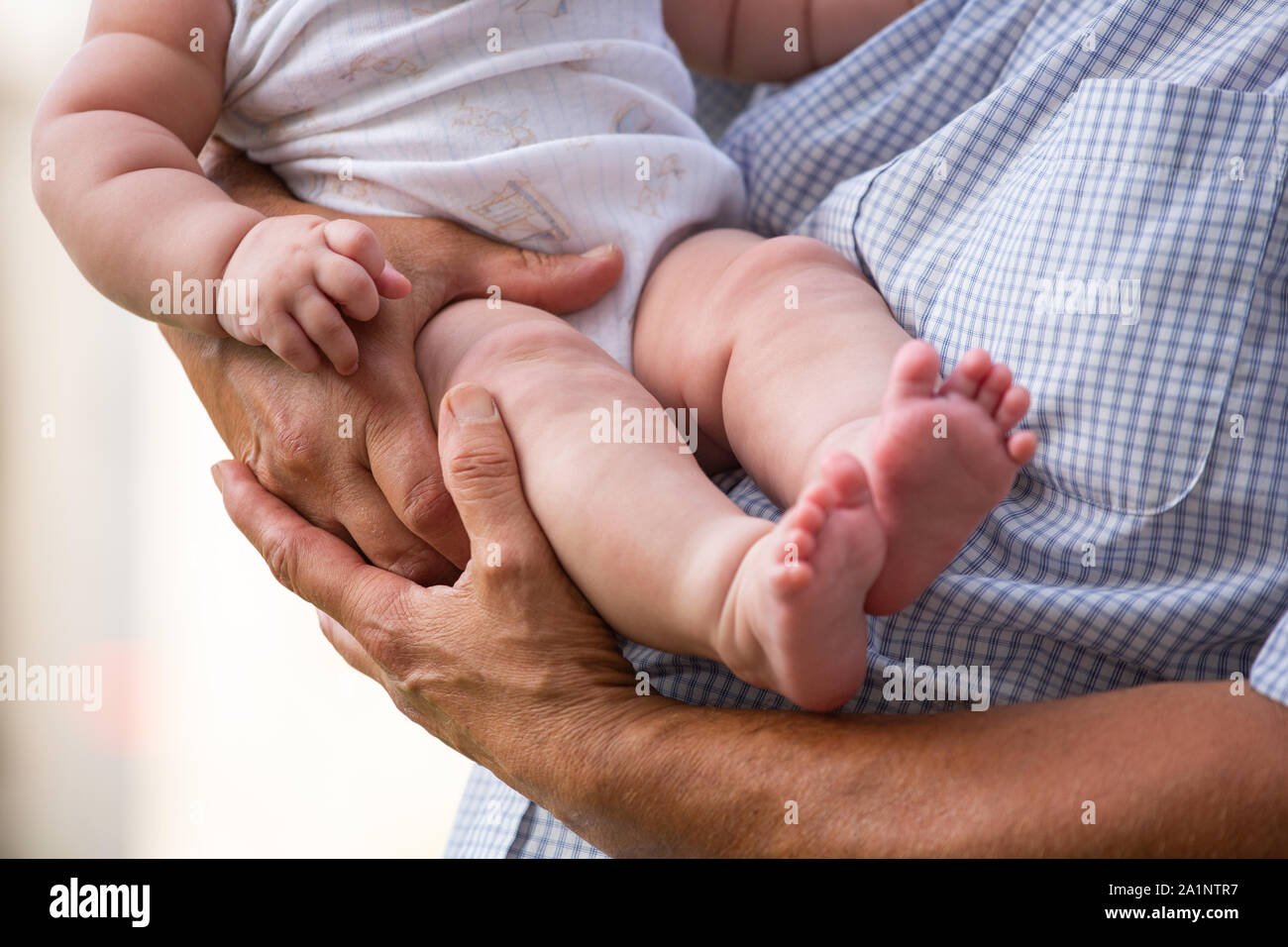 A father holds a baby in his arms Stock Photo