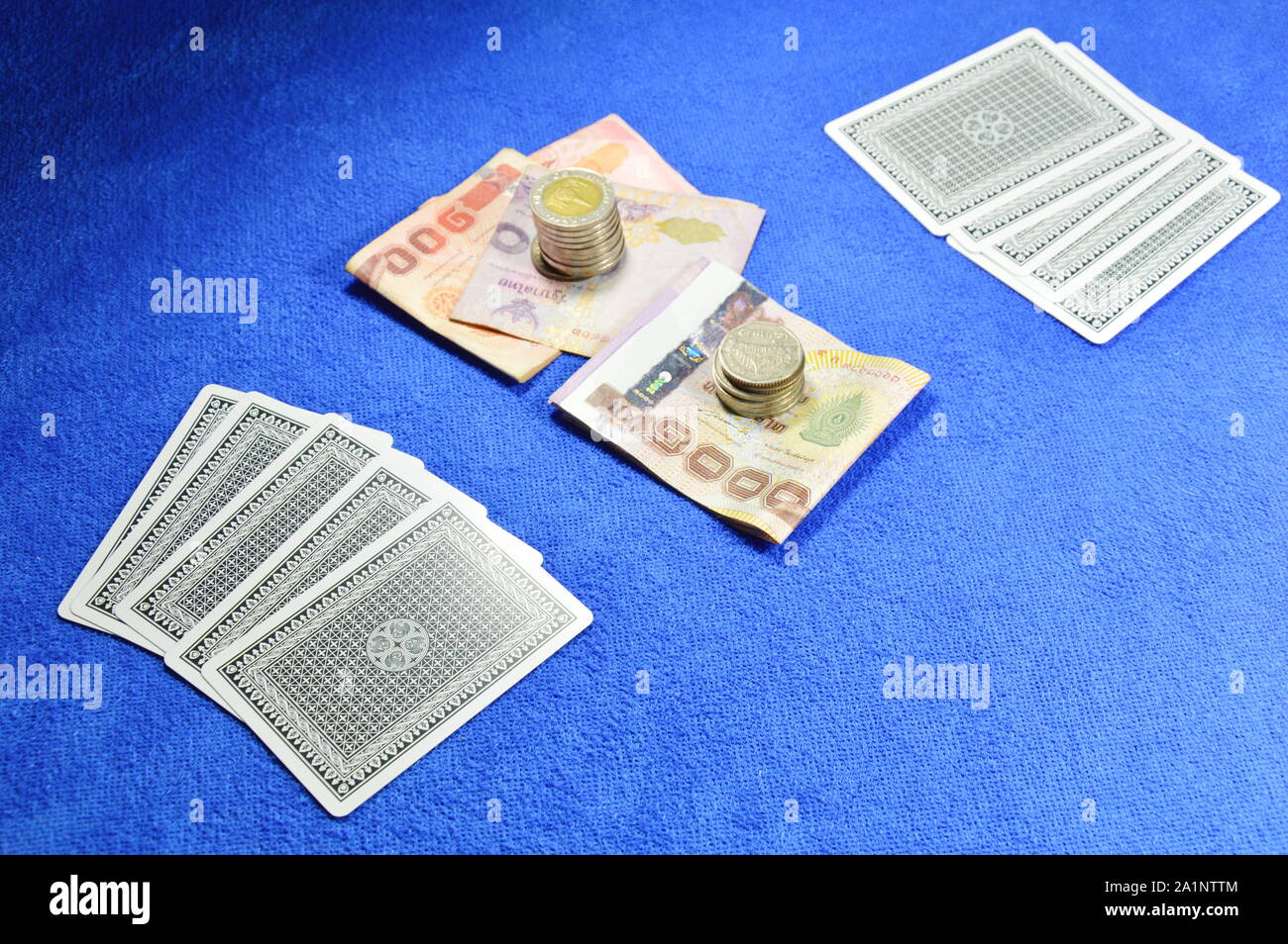 poker card fold and money bet on blue velvet table waiting for challenge Stock Photo