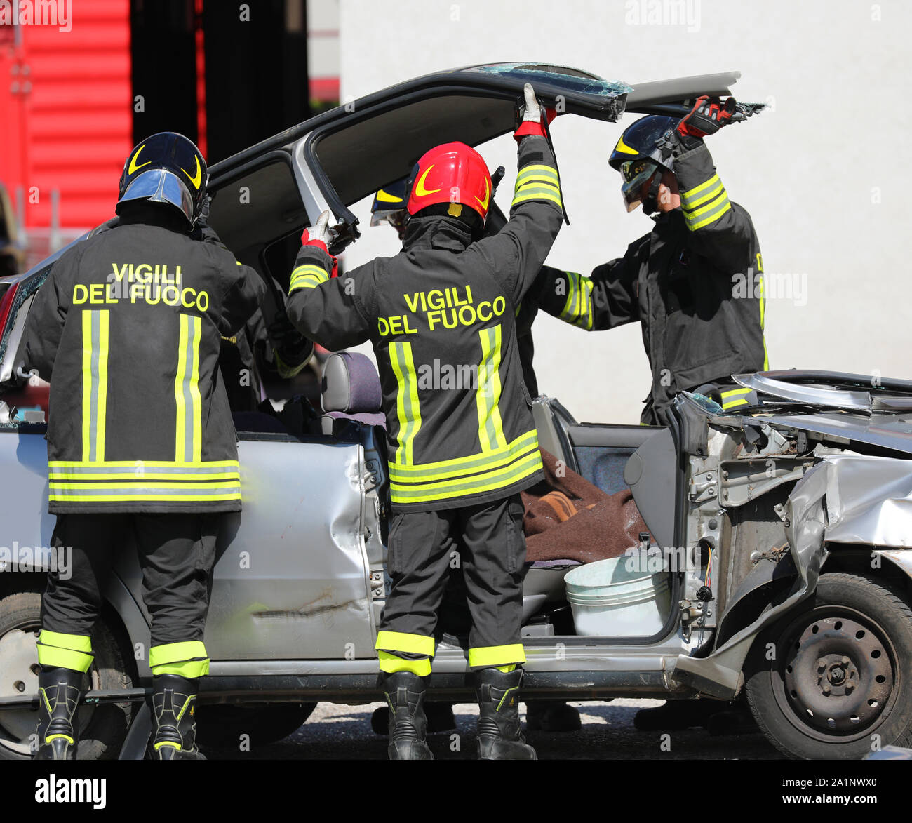 Rome, RM, Italy - May 16, 2019: italian firemen raise the roof of the car to extract the wounded after road accident Stock Photo
