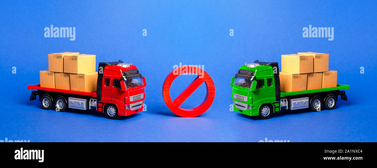 Prohibition sign NO between two trucks. Embargo trade wars. Restriction