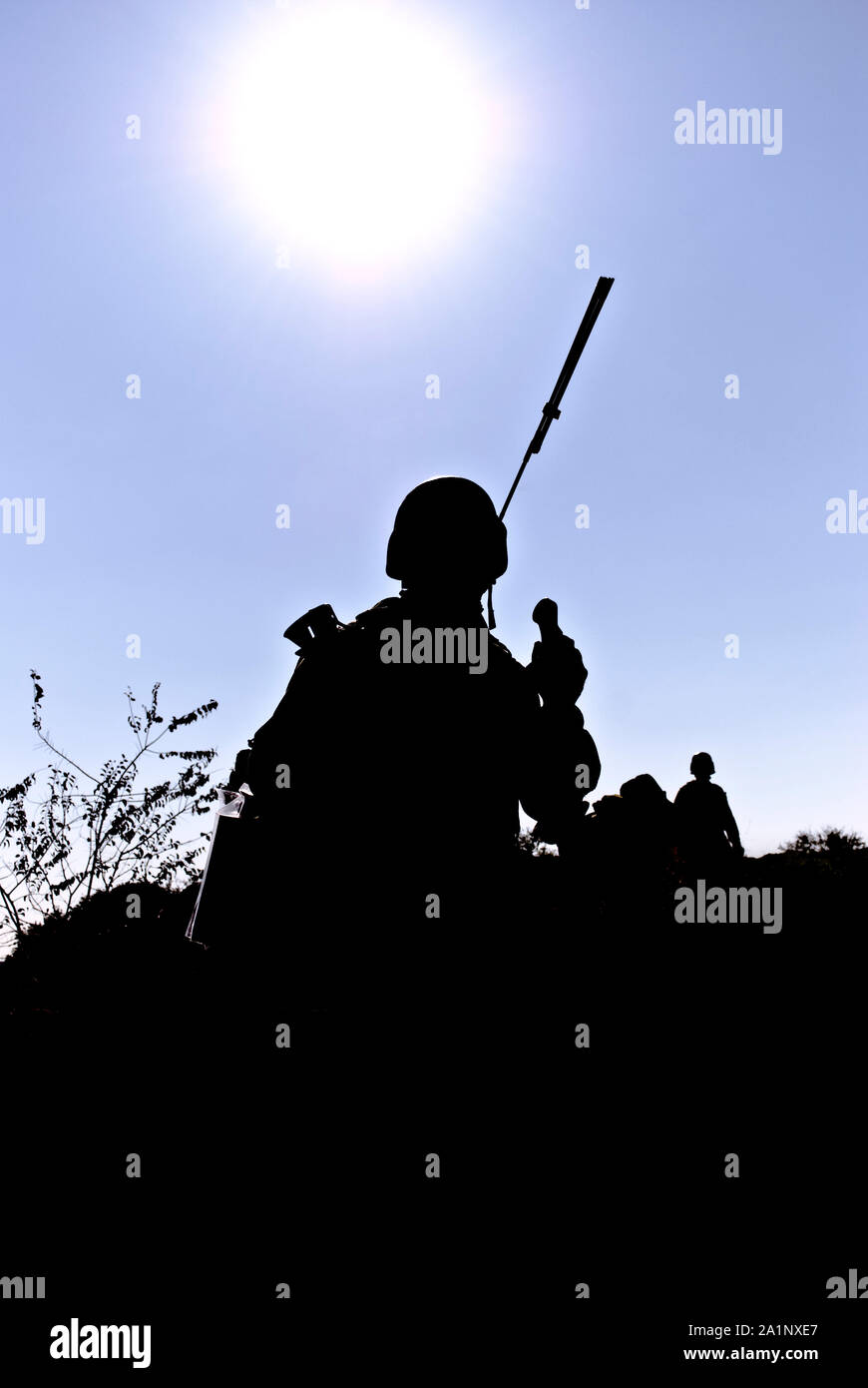 A silhouette of the military person on a background of the sun Stock Photo
