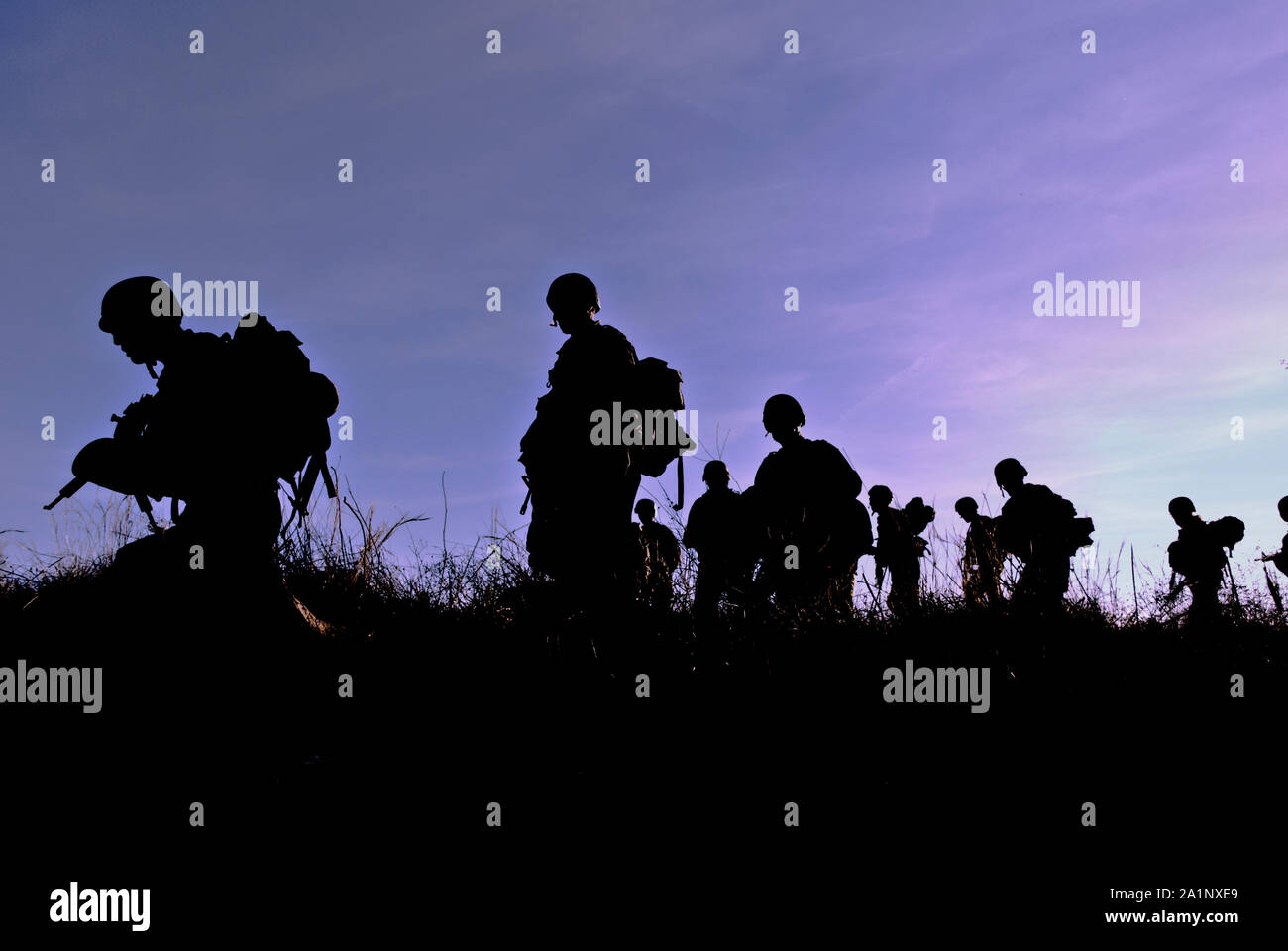 Army soldiers patrolling during sunset Stock Photo