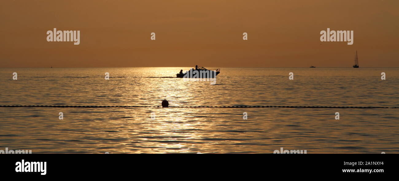 sunset with a yacht in the background Stock Photo - Alamy