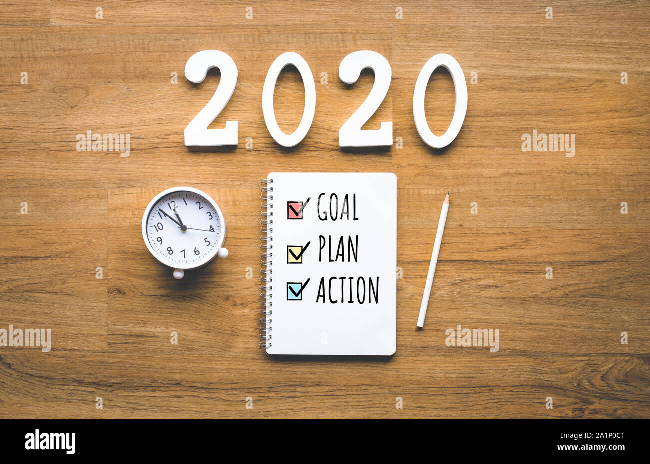 2020 new year goal,plan,action text on notepad on wood background.Business challenge.Inspiration ideas.Human performance Stock Photo