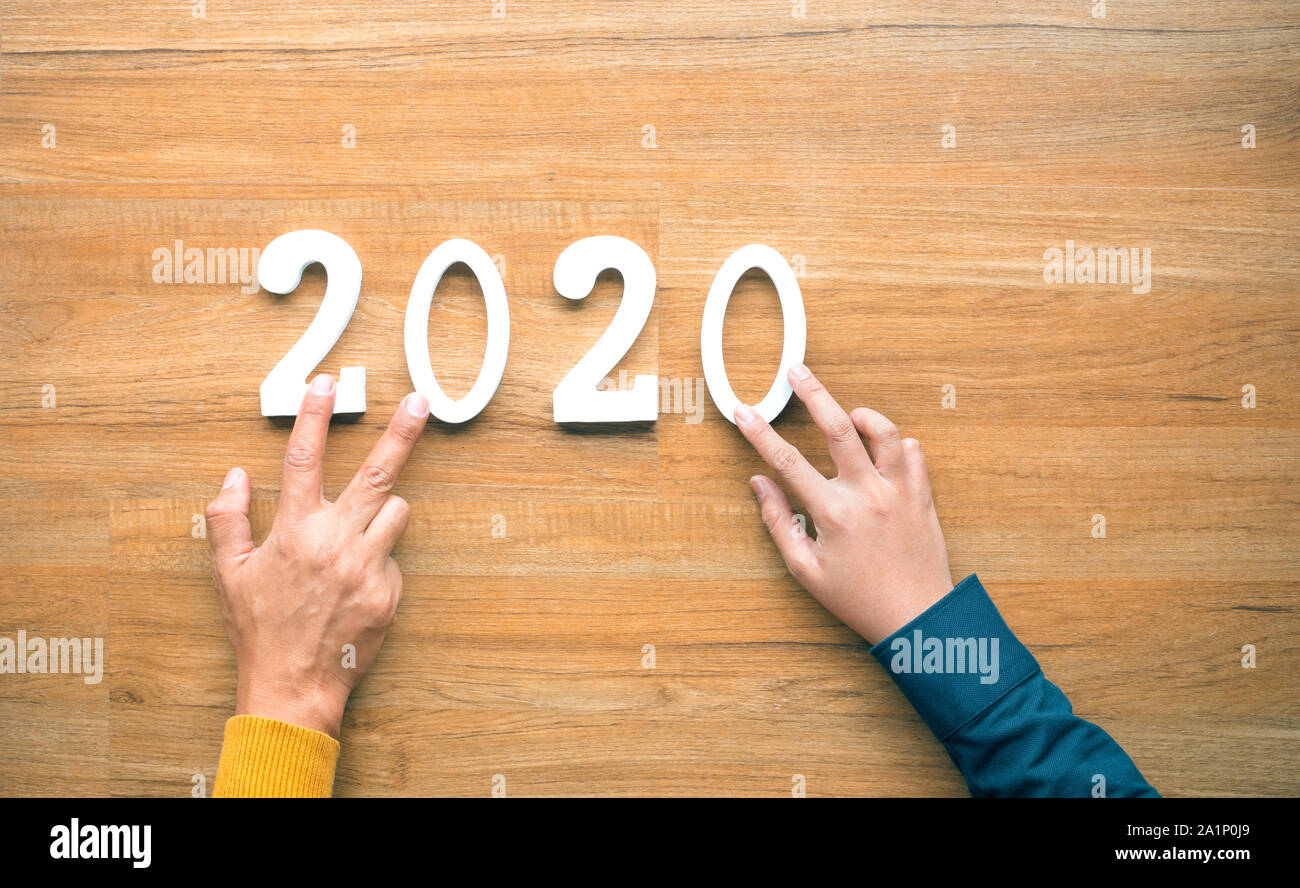 2020 new year celebration concepts with text number and human hand on wood background. inspiration and motivation ideas Stock Photo