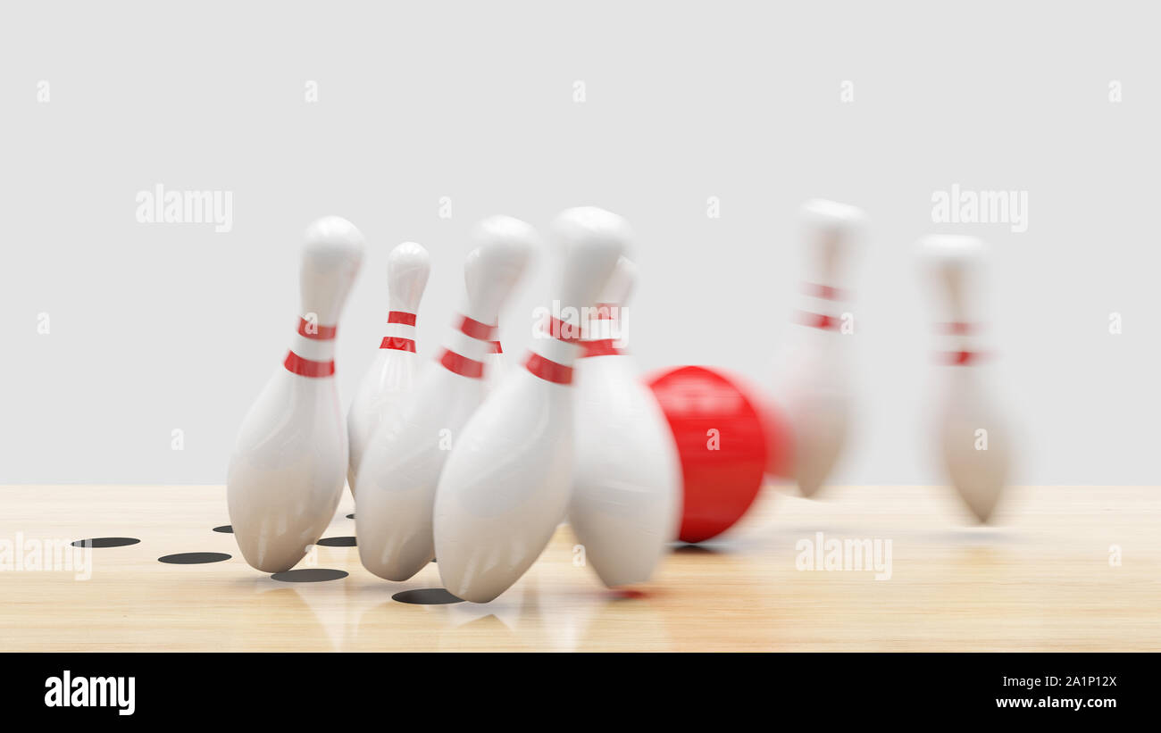 Bowling strike, Red ball knocks down bowling pins. Stock Photo