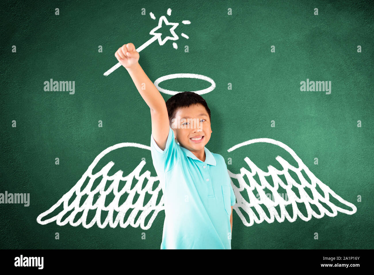 kid standing against chalkboard and magic   concept Stock Photo