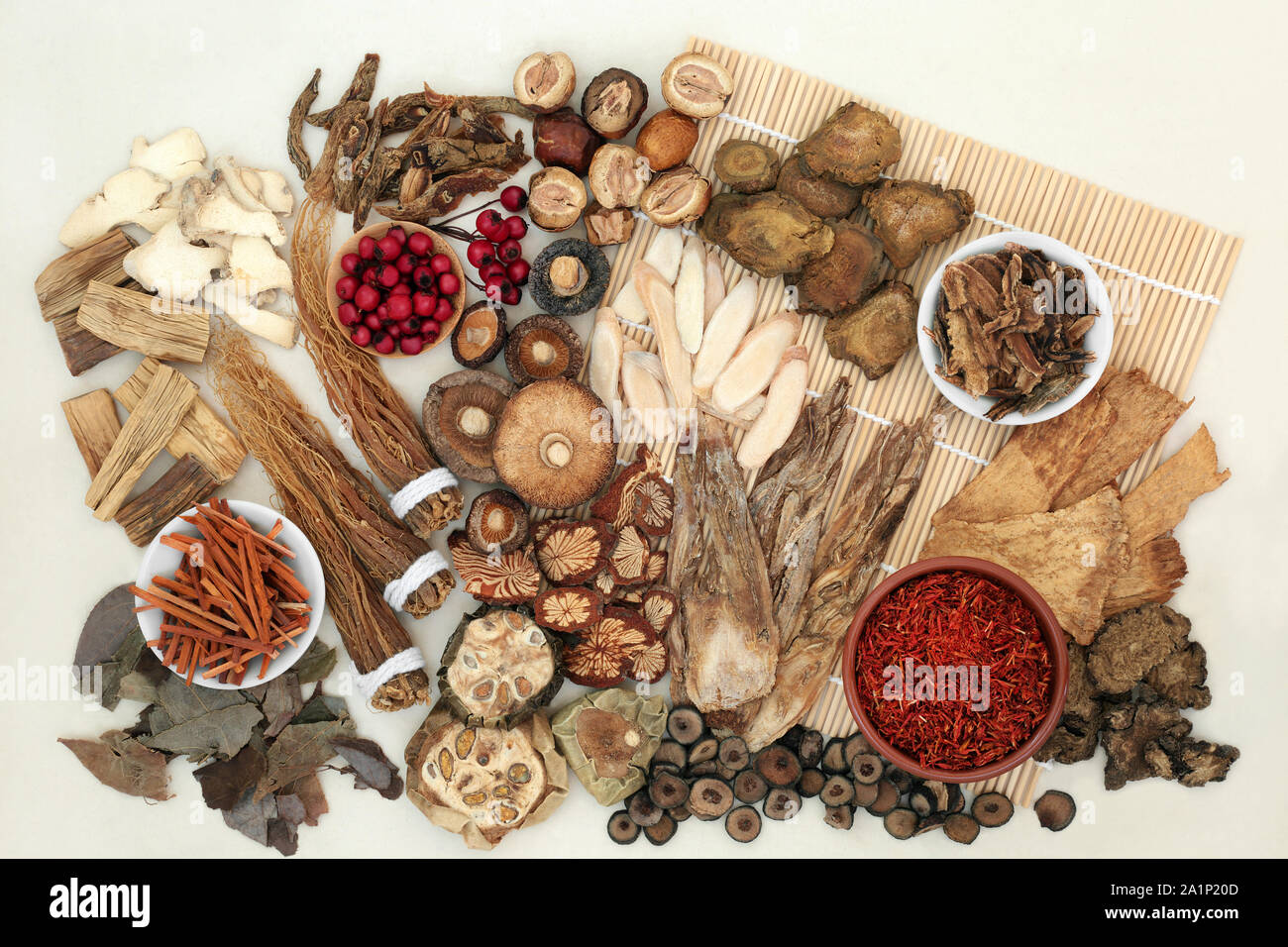 Chinese herbs used in traditional herbal medicine on a bamboo mat and ...