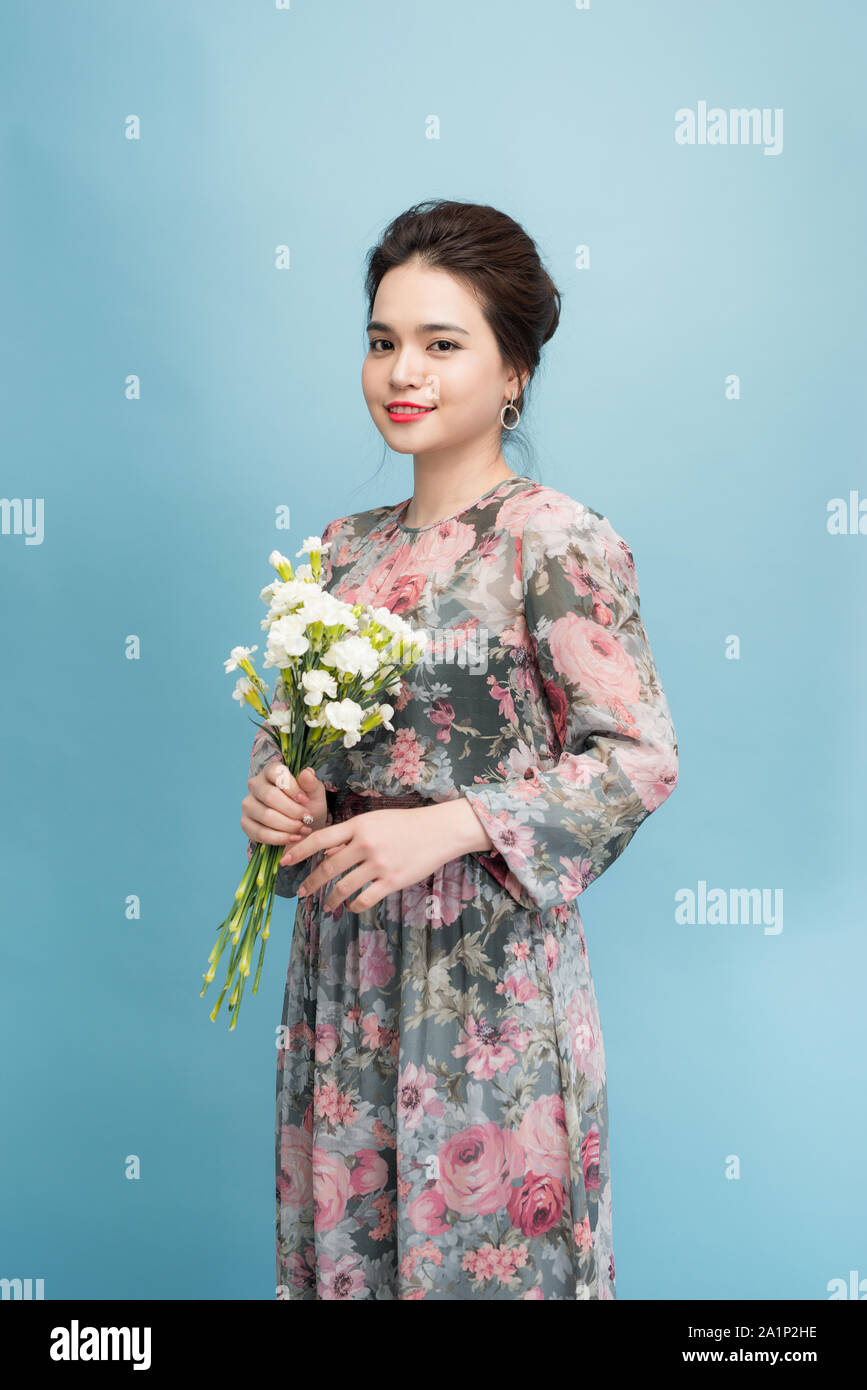 Portrait of a beautiful young woman in blue background Stock Photo - Alamy