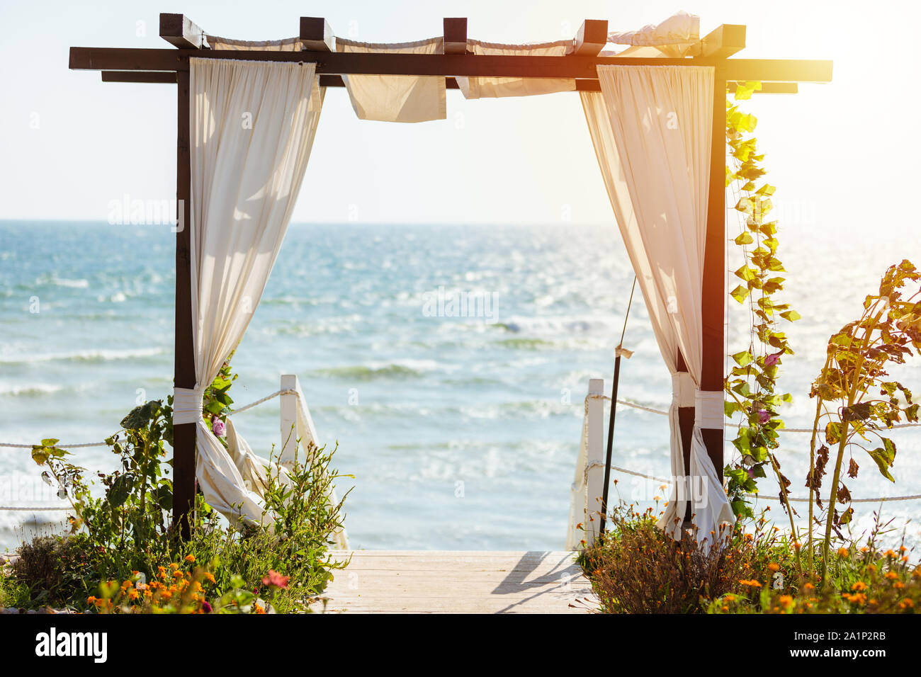 Decorated archway with sea on background in summer day. Useful as travel, brochure, wedding, presentation background Stock Photo