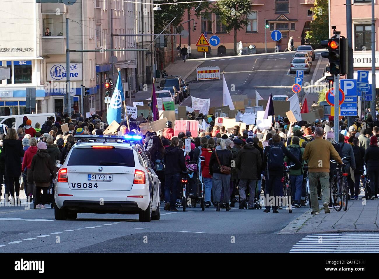 Turku, Finland - September 27, 2019: Police car behind climate demonstrators. Stock Photo