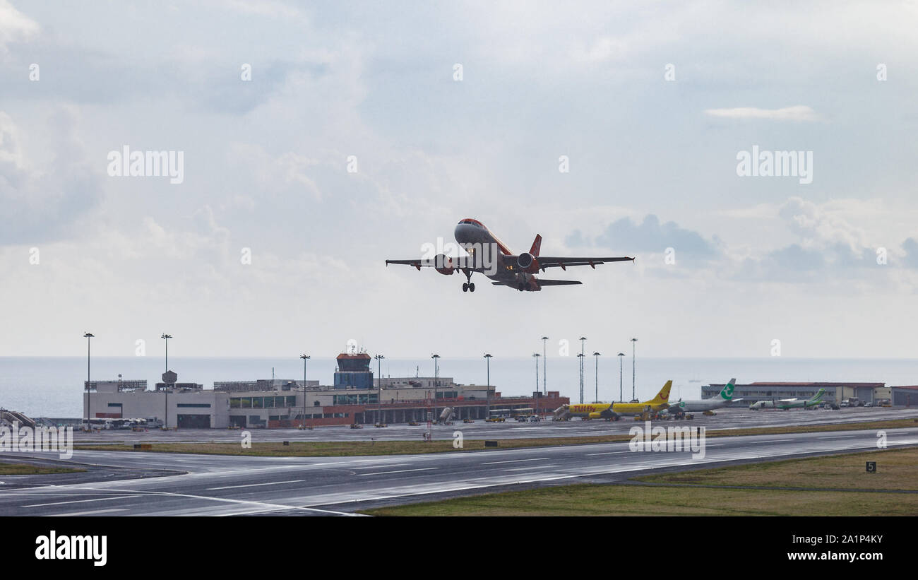 FUNCHAL, PORTUGAL - SEPTEMBER 2019: A Easyjet airplane taking off from Cristiano Ronaldo International Airport at Madeira in a rainy day. Stock Photo