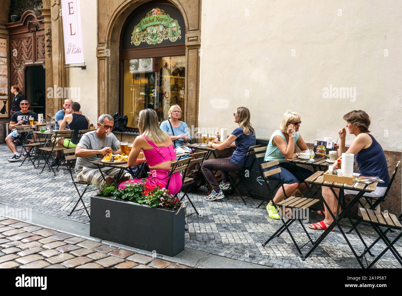 Prague tourists sitting outside a bar 'U Kocku' Jilska Street Old Town Prague Czech Republic Stock Photo