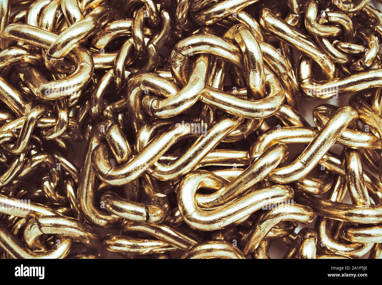 Tangled gold chain close up. Textured metallic background Stock Photo