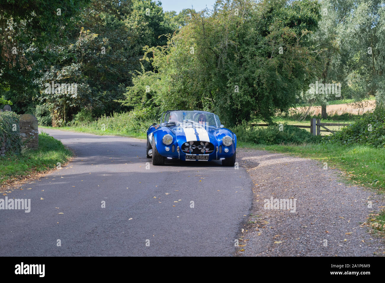 AC Cobra Pilgrim  replica leaving to a classic car show in the Oxfordshire countryside. Broughton, Banbury, England Stock Photo