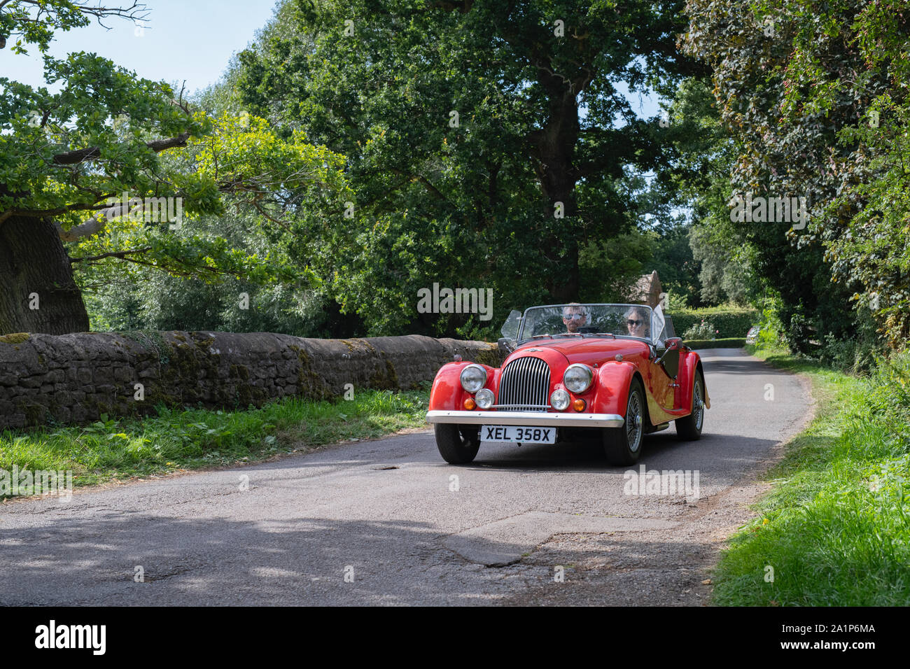 1982 Morgan 4/4 leaving to a classic car show in the Oxfordshire countryside. Broughton, Banbury, England Stock Photo