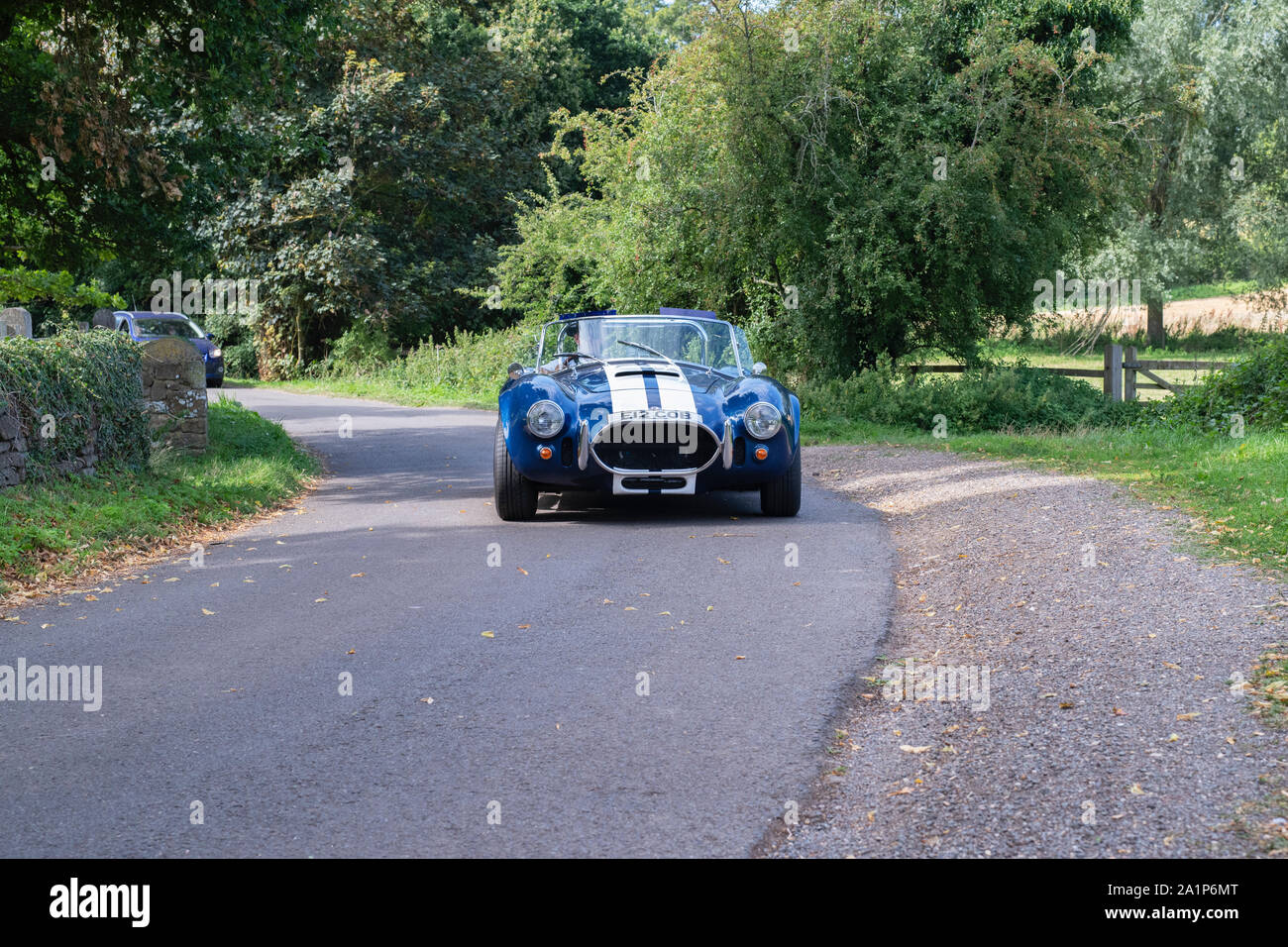 AC Cobra replica leaving to a classic car show in the Oxfordshire countryside. Broughton, Banbury, England Stock Photo