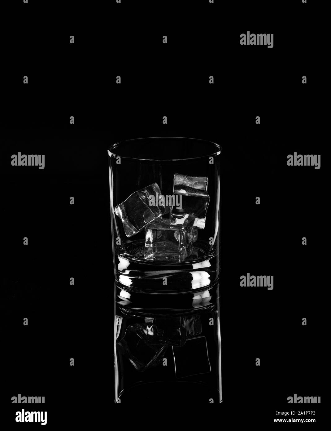 Glass with ice cubes a black background. Monochrome Stock Photo - Alamy