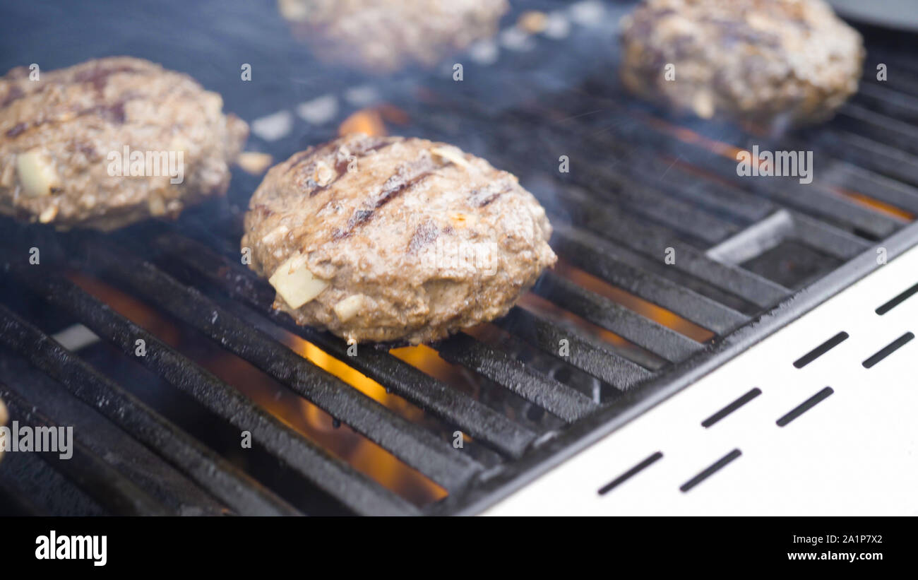 Cooking hamburger beef patties on a gas grill Stock Photo Alamy