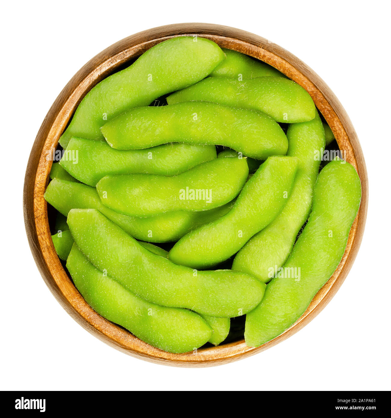 Edamame, green soybeans in the pod, in wooden bowl. Unripe soya beans, also Maodou. Glycine max, a legume, edible after cooking. Protein source. Stock Photo
