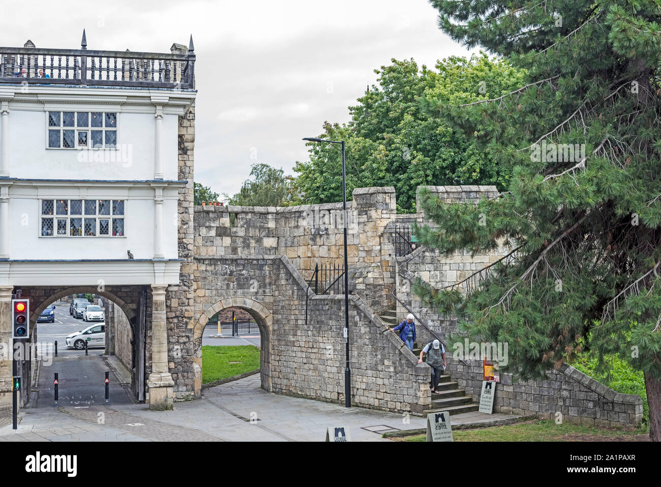 People on the steps of the York city boundary wall at the Walmgate Bar