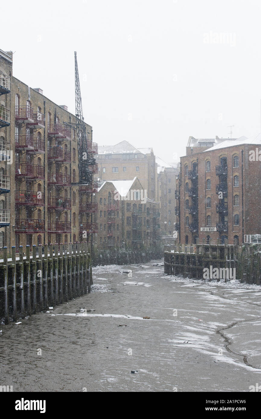 Snow, Java Wharf, Victorian warehouse now converted into luxury apartments near Tower Bridge, London, Britain. Stock Photo