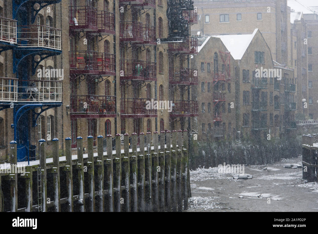 Snow, Java Wharf, Victorian warehouse now converted into luxury apartments near Tower Bridge, London, Britain. Stock Photo
