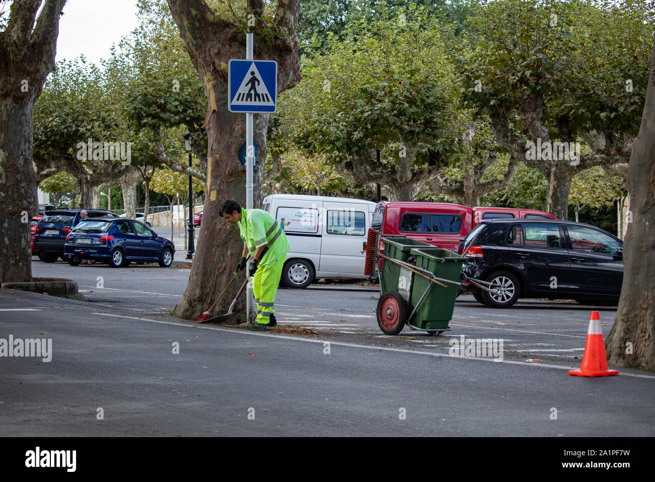 Cambre / Spain - September 24 2019: Street sweeper clearing leaves from the road in Cambre Spain Stock Photo