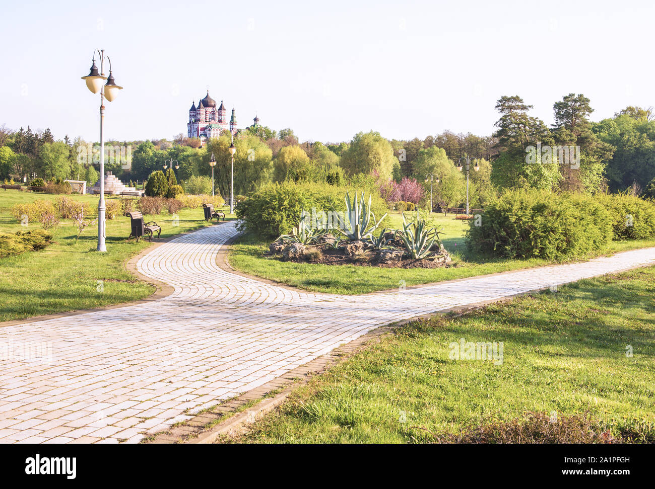 Beautiful alley in the spring park Feofania, Kiev, Ukraine. In the background St. Panteleimon Cathedral is the main temple of the convent. Stock Photo