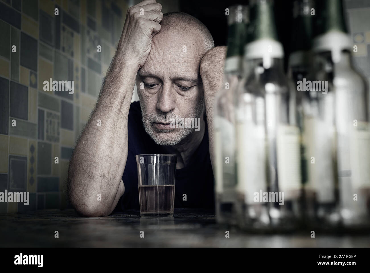 A desperate man falls into depression and becomes alcoholic and miserable. His addiction leads him to a state of loneliness and poverty. He has no hop Stock Photo