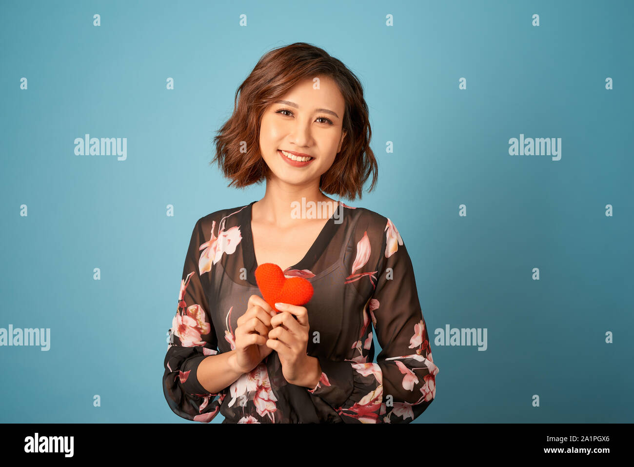 Love from first sight. Woman in stylish dress hold symbol love. Stock Photo