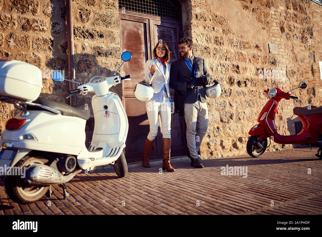 Smiling couple on motor scooter. Happy Italian Couple on Scooter. Stock Photo