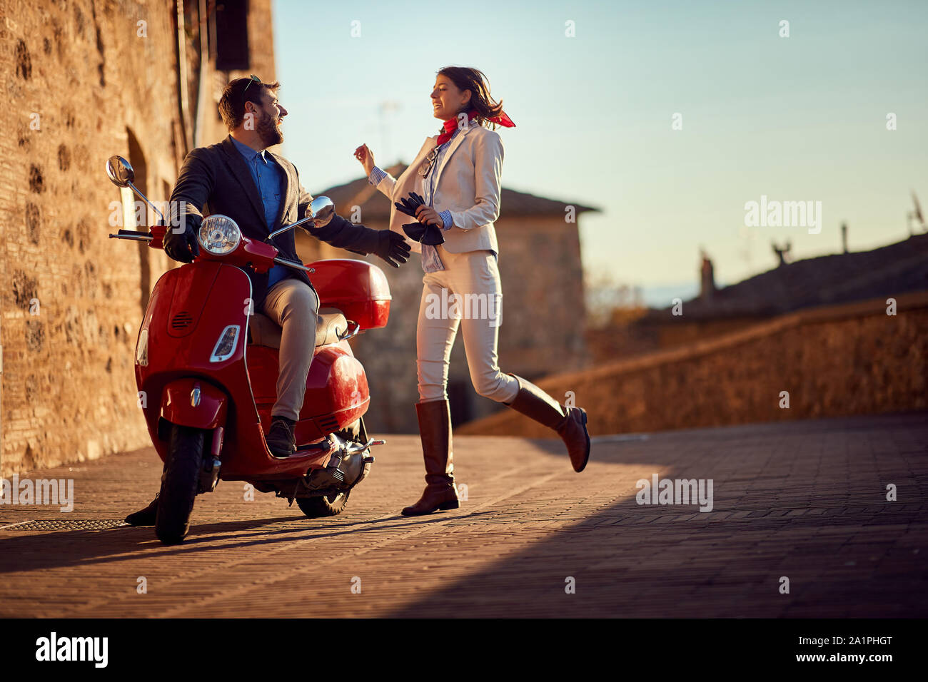 Business people on scooter. scooter in the city. Young Happy couple riding scooter. Stock Photo