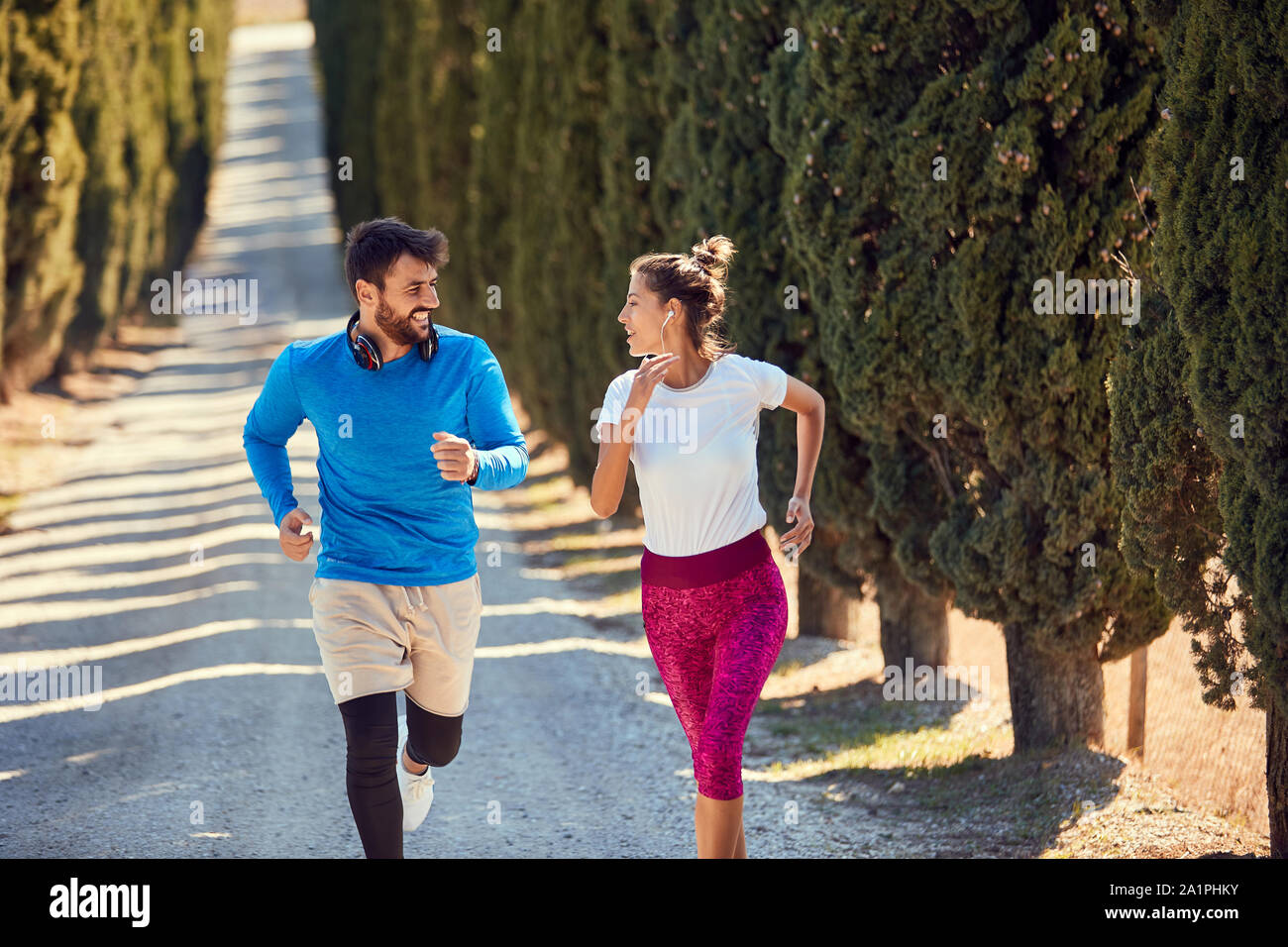 young sporty couple jogging together outdoors Stock Photo - Alamy
