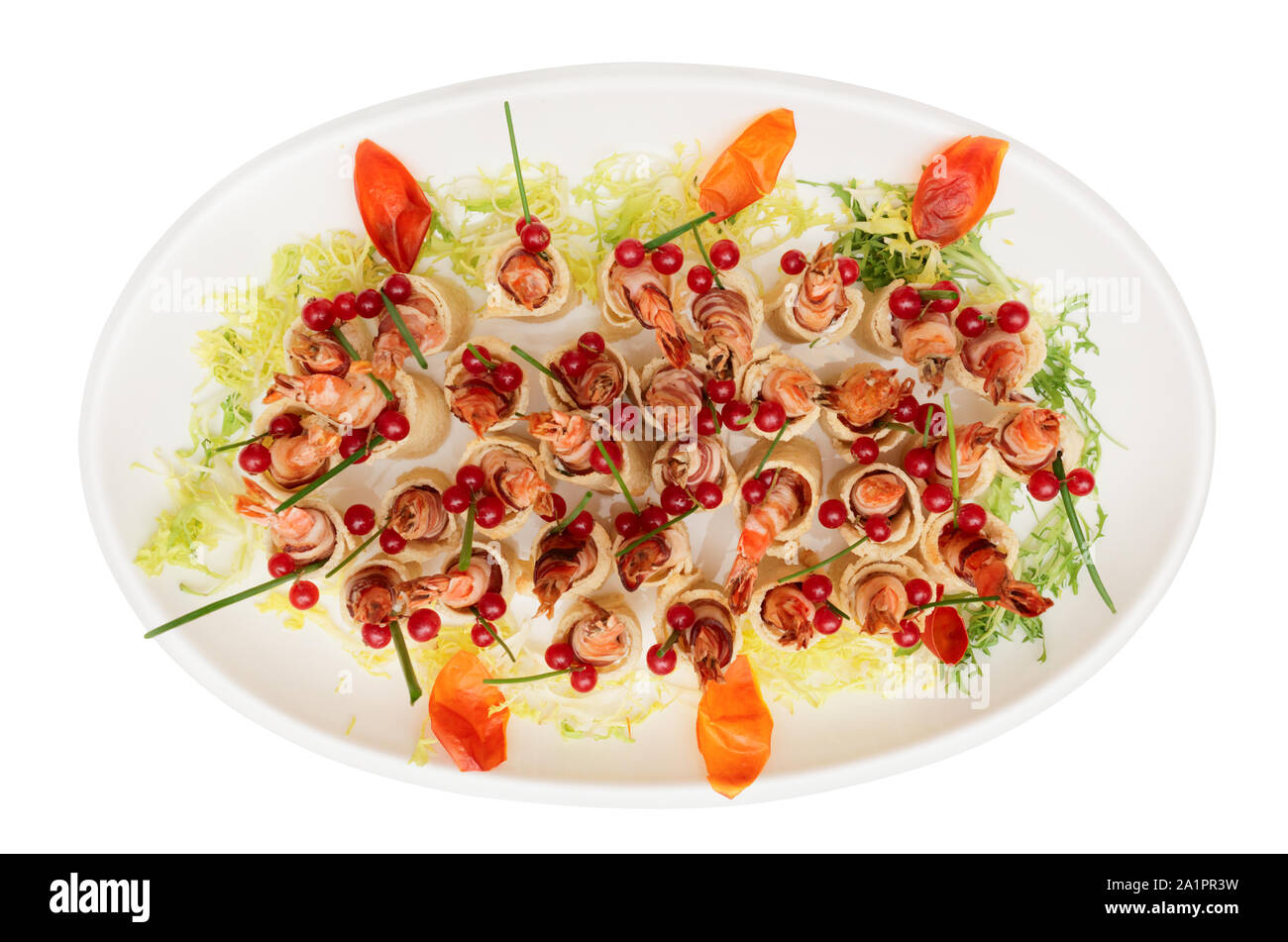 Grilled shrimps wrapped in bacon in plate isolated on white Stock Photo
